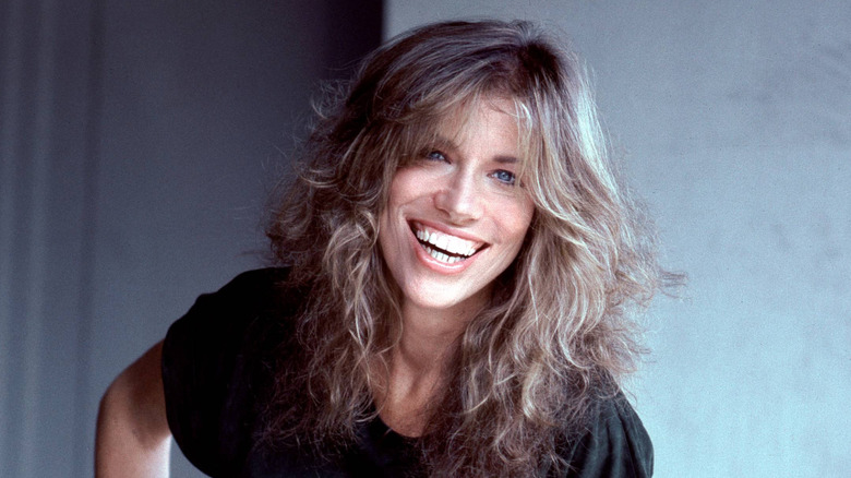 Carly Simon en un retrato en 70 en blusa negra sonriendo