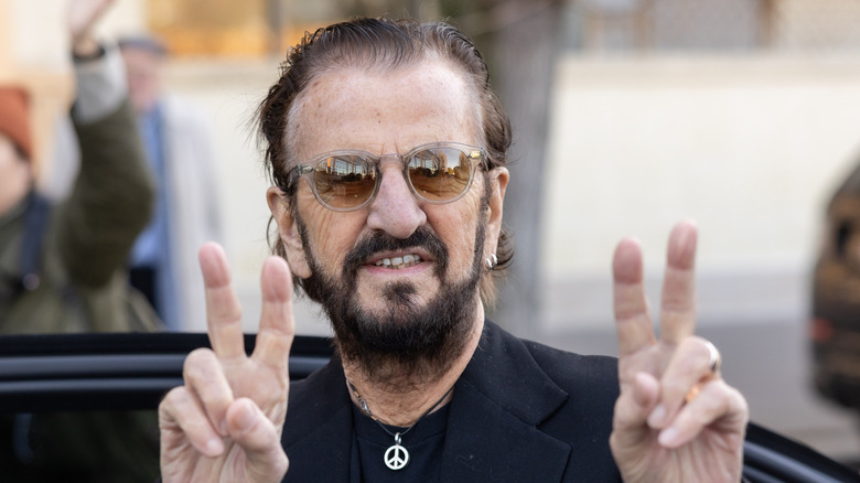 Ringo Starr ofreciendo un signo de paz en 2024