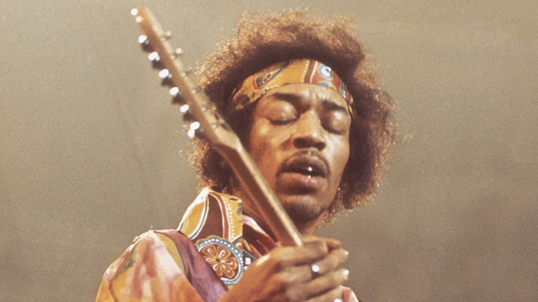 Jimi Hendrix tocando guitarra en escenario